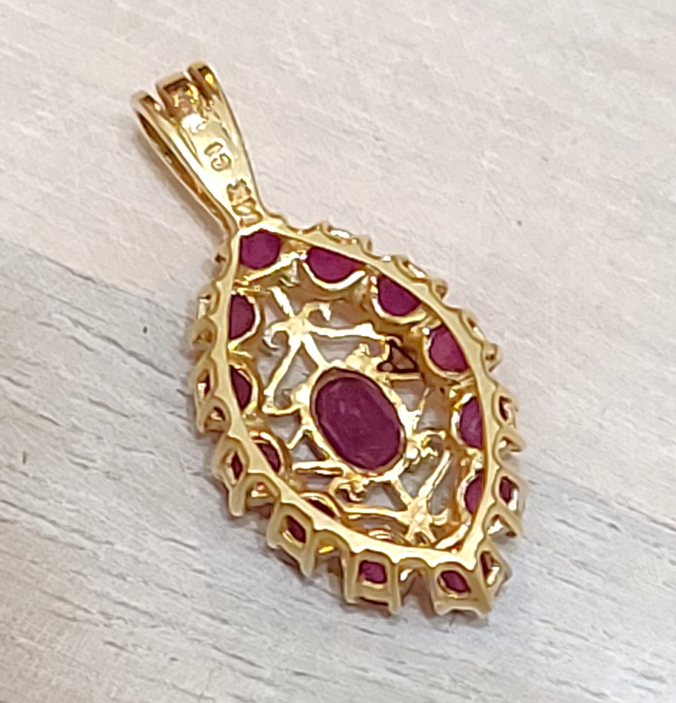 14K gold pendant with genuine ruby gemestones