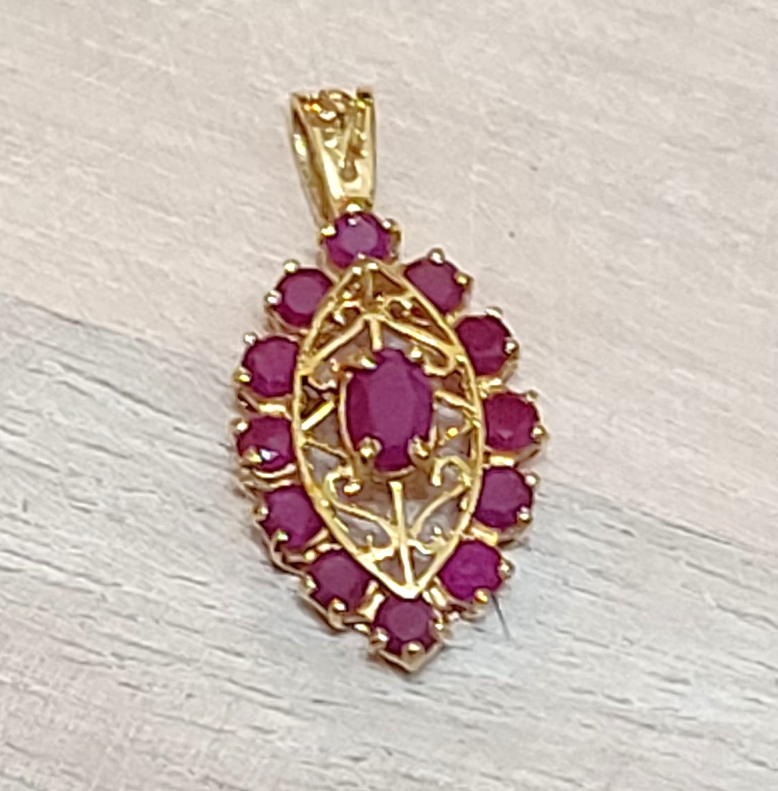 14K gold pendant with genuine ruby gemestones