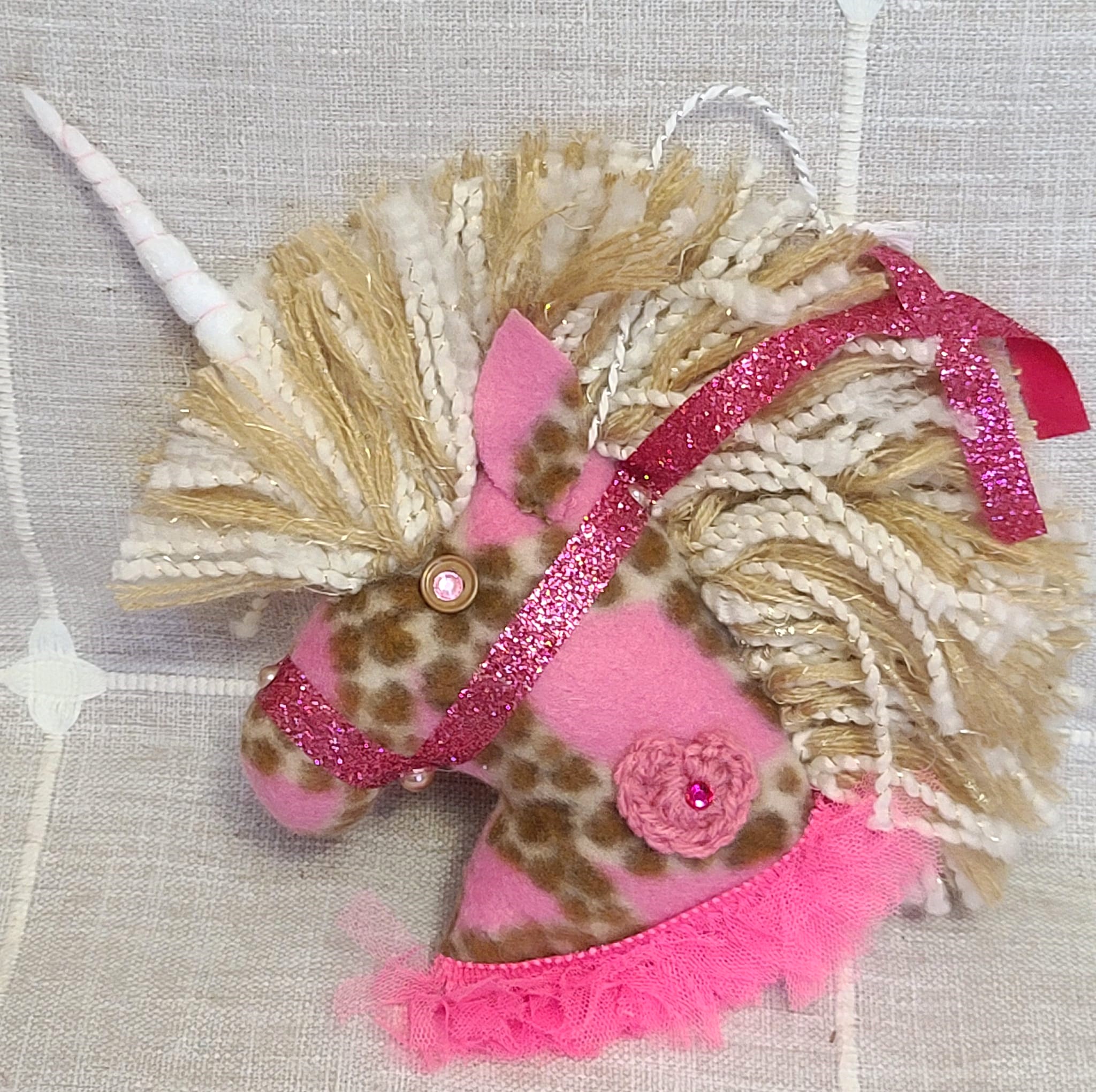 Unicorn felt ornament with brown spots and pink trim
