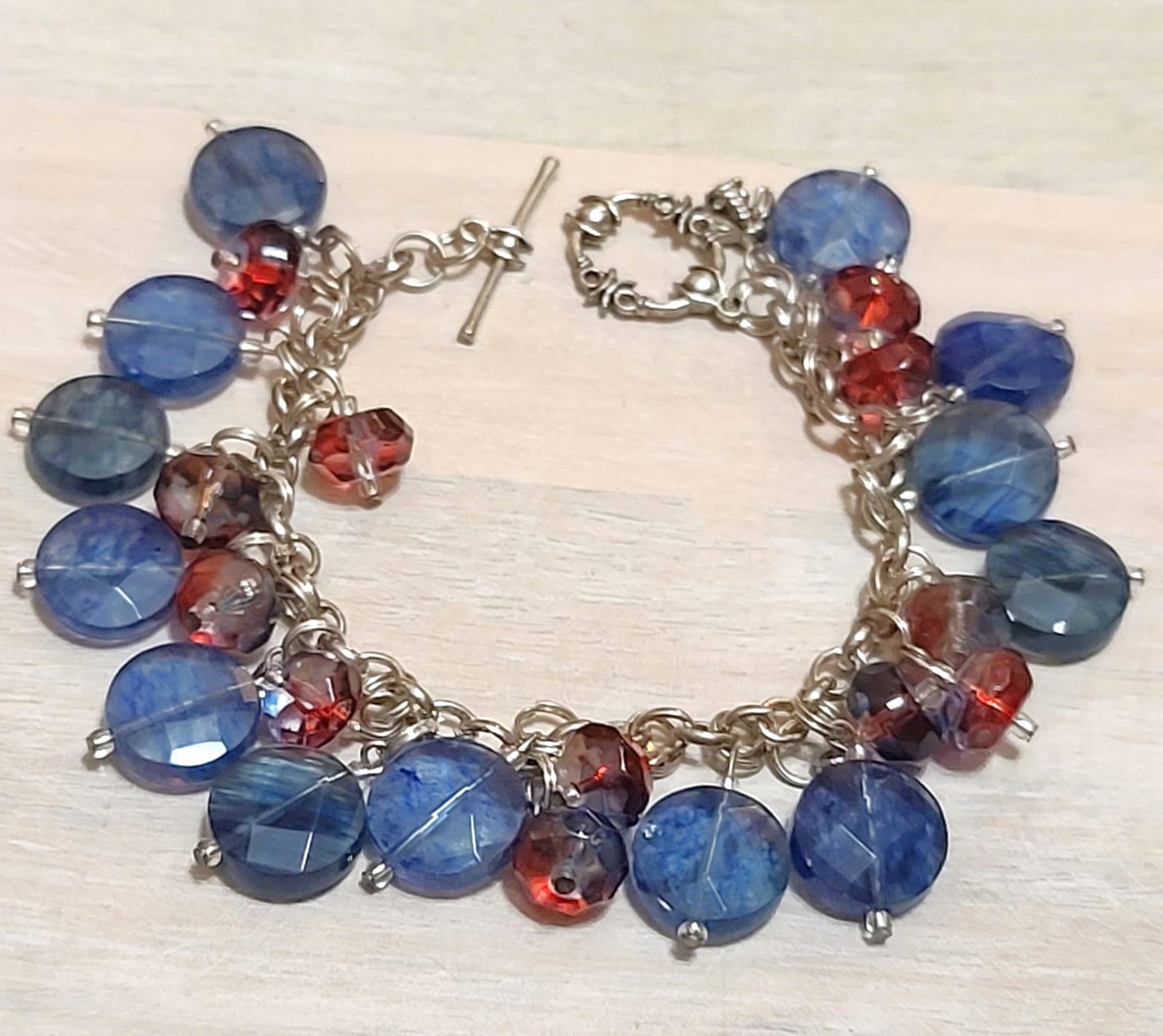 Charm bracelet, handcrafted, blue and red glass faceted beads, charms with bee silver charm