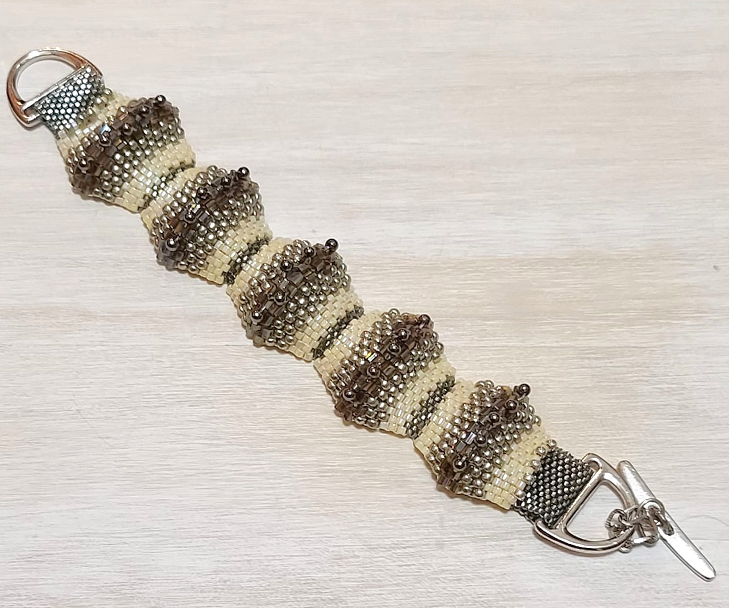 Miyuki glass bracelet, raised humps of silver, crystals, ivory