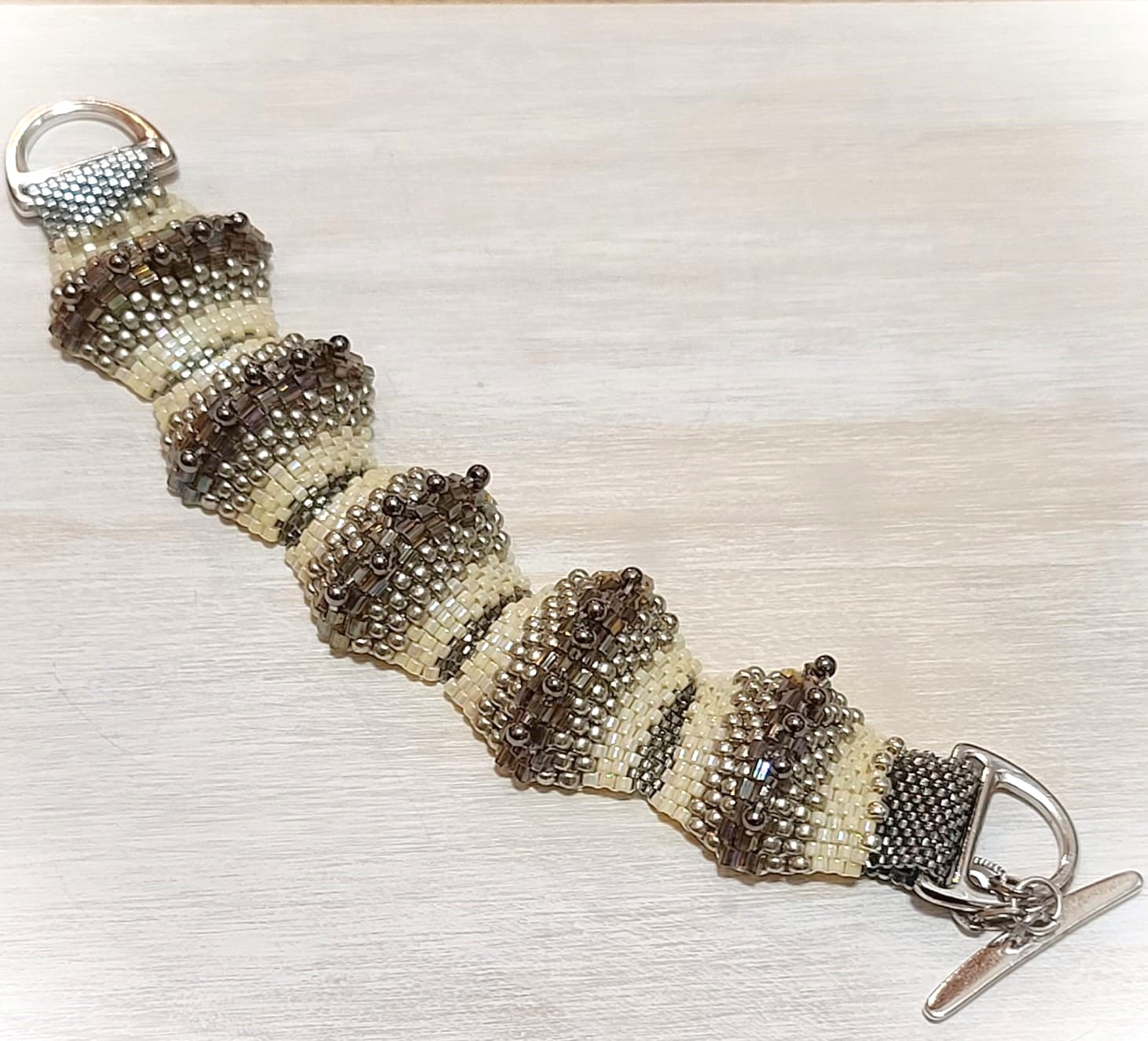 Miyuki glass bracelet, raised humps of silver, crystals, ivory