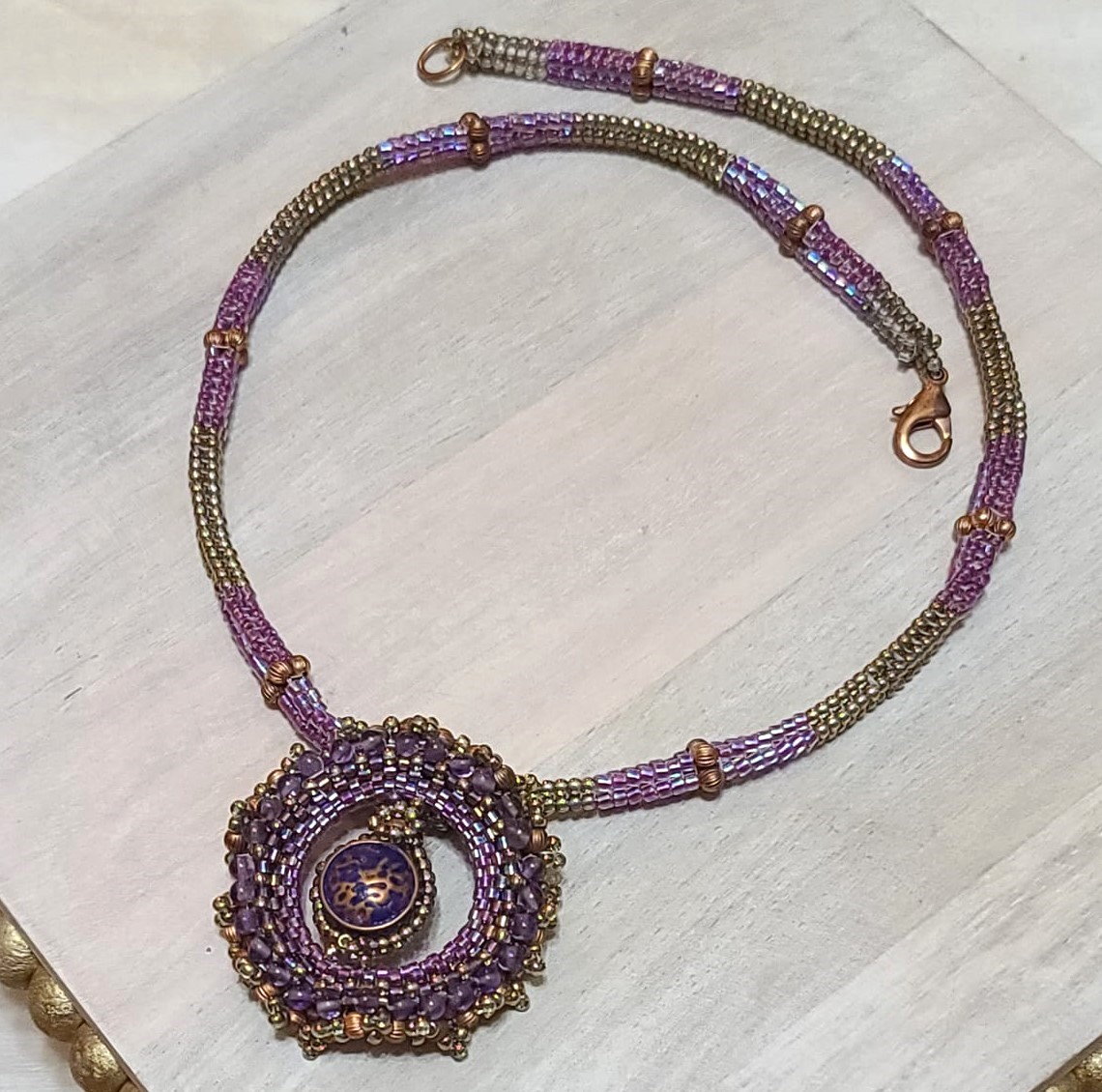 Beaded pendant purple and copper accents, peyote stitch rope