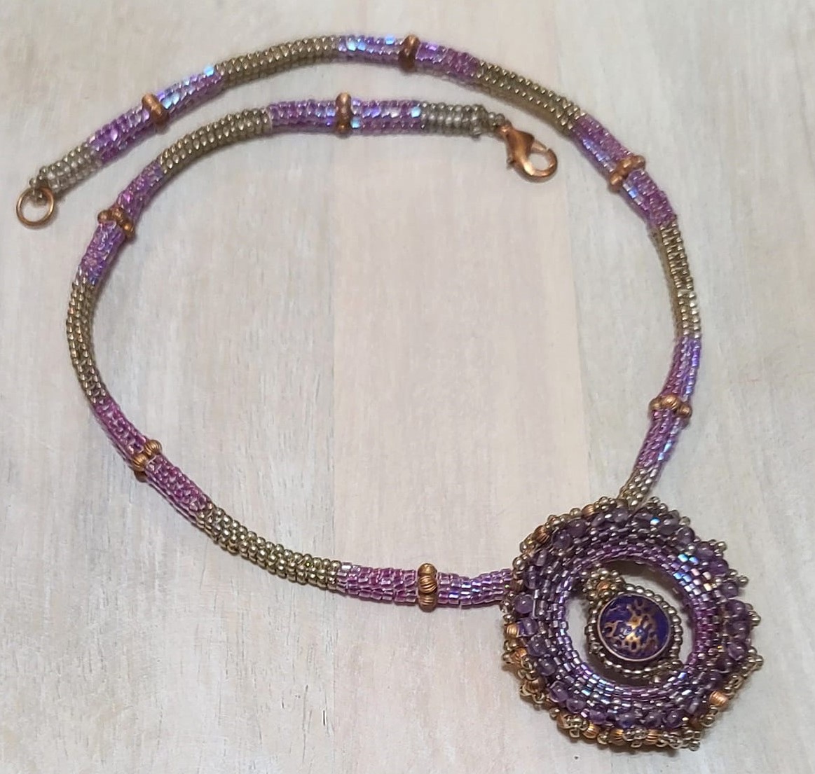 Beaded pendant purple and copper accents, peyote stitch rope
