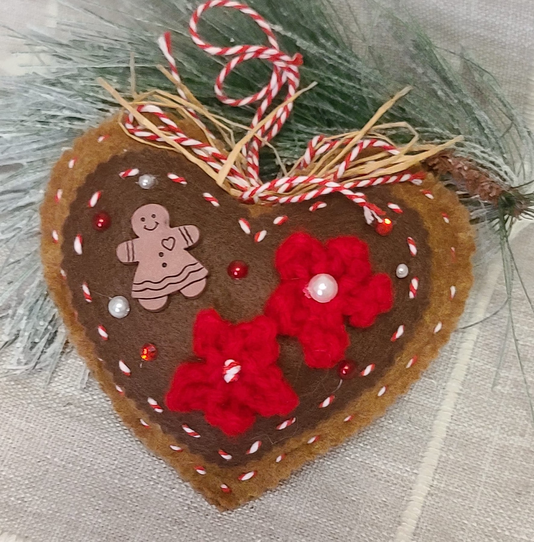 Gingerbread and chocolate icing with red accents heart ornament