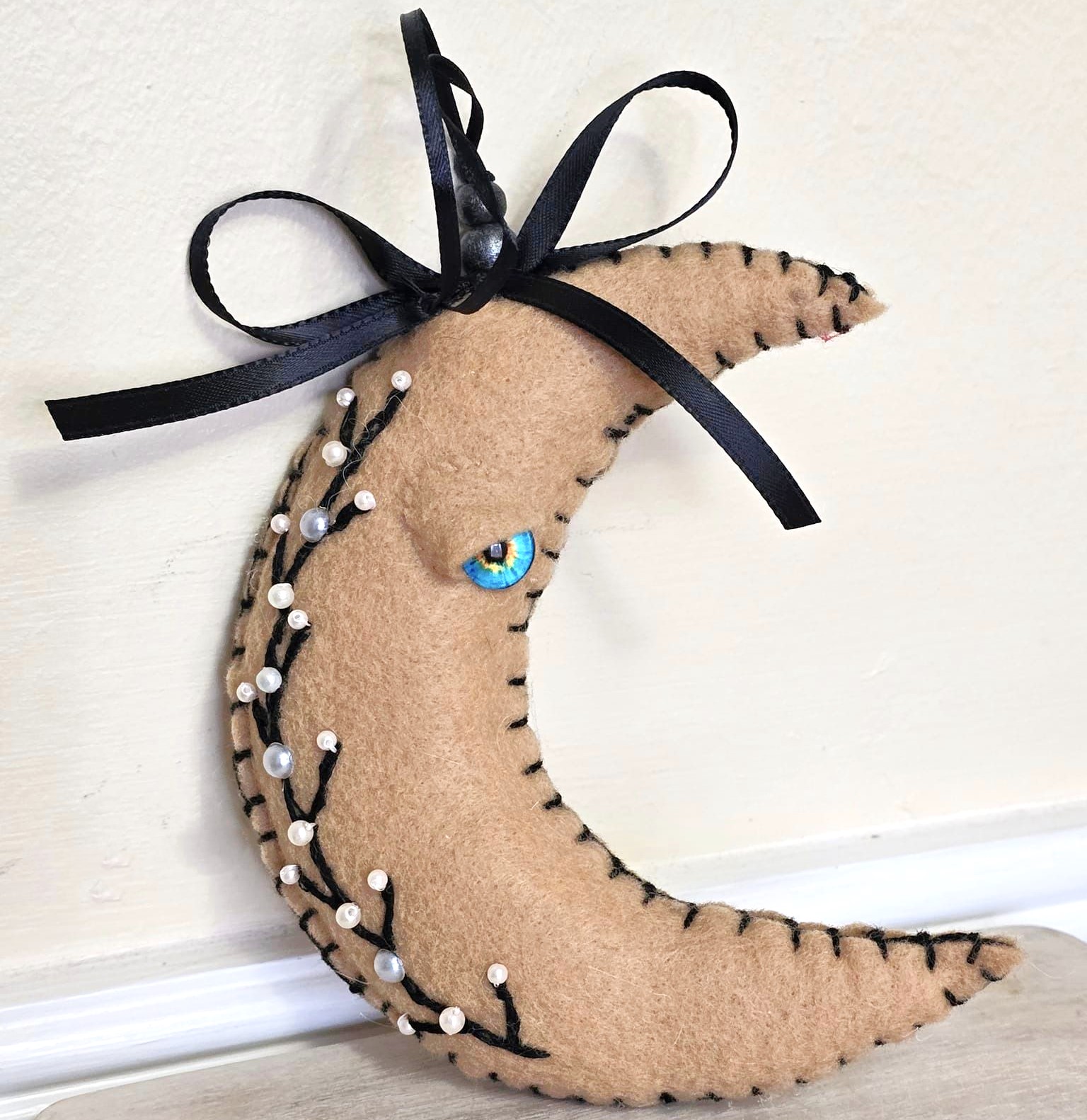 Moon ornament, beige moon with black embroidery, whimsical, handcrafted moon, felt, embroidery, bead accents