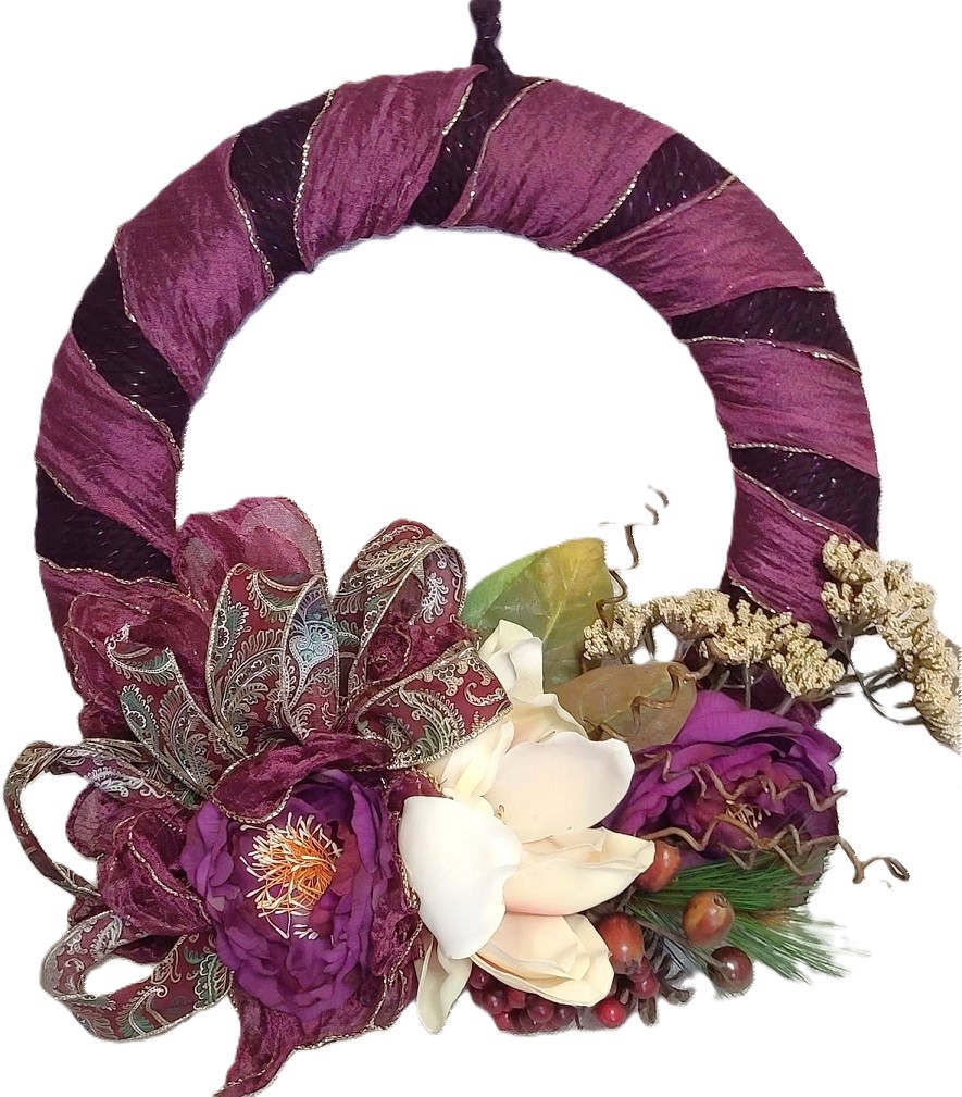Handmade floral wreath, with purple foilage, magnolia flowers and baby's breath arrangement