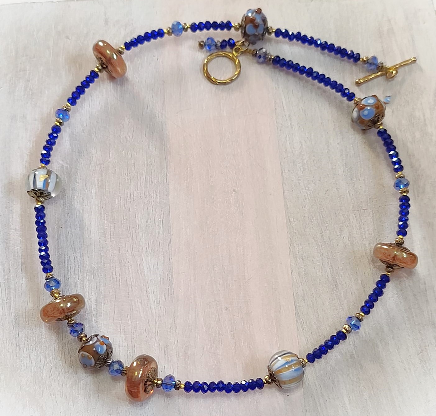 Lampwork glass necklace, blues and tawny brown with cyrstals