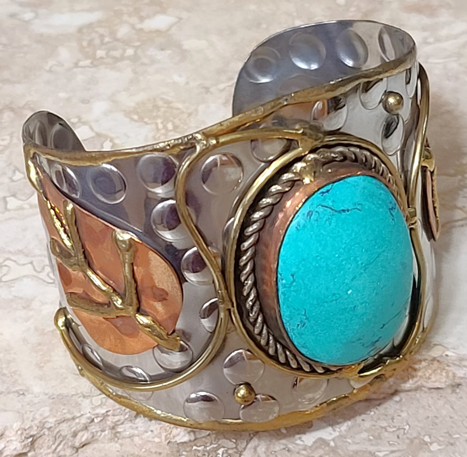 Cuff bracelet, with center howlite gemstone, tri color metals, copper, silver and brass