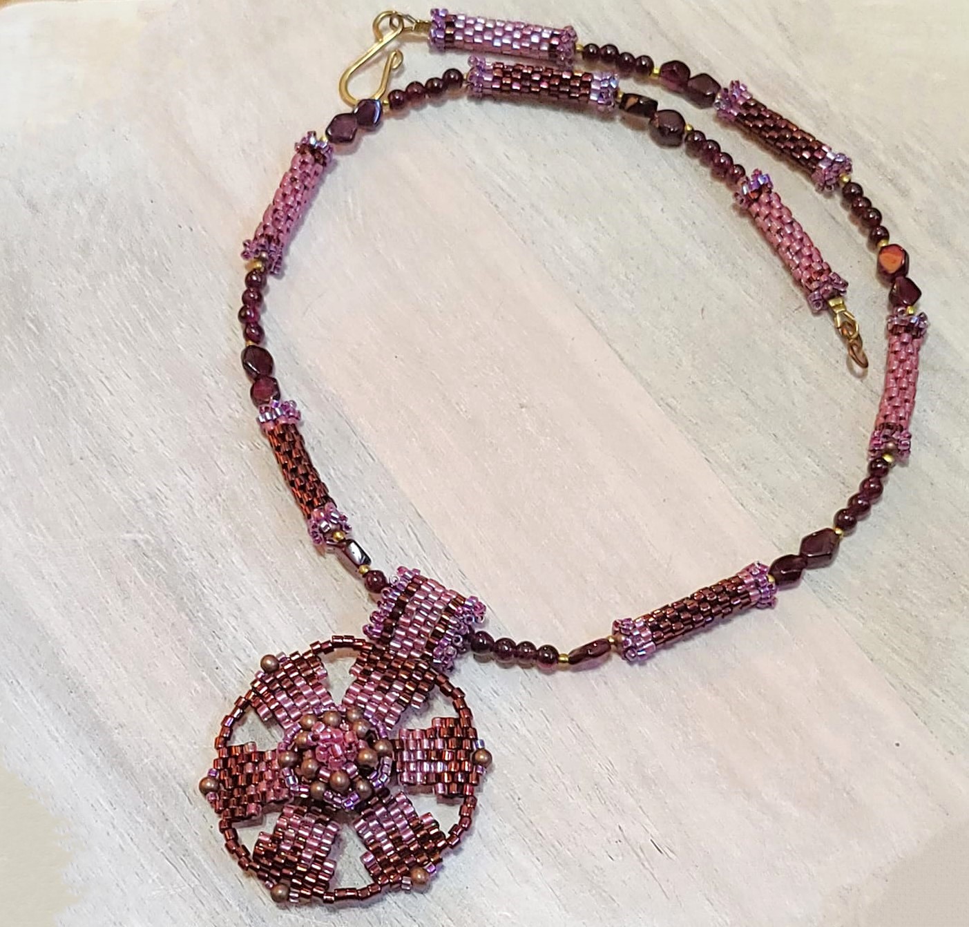 Garnet pendant necklace, center flower design with gems