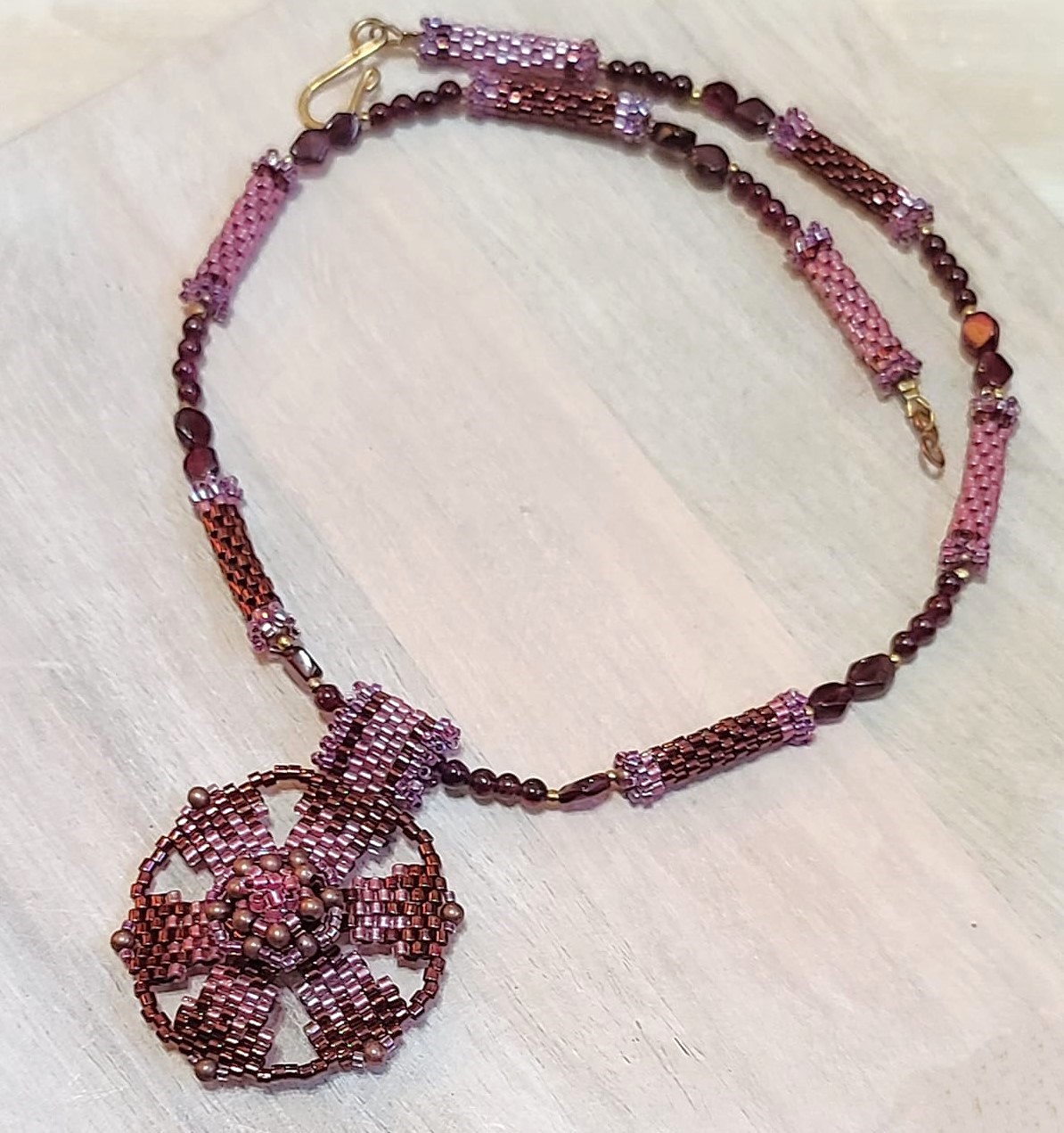Garnet pendant necklace, center flower design with gems