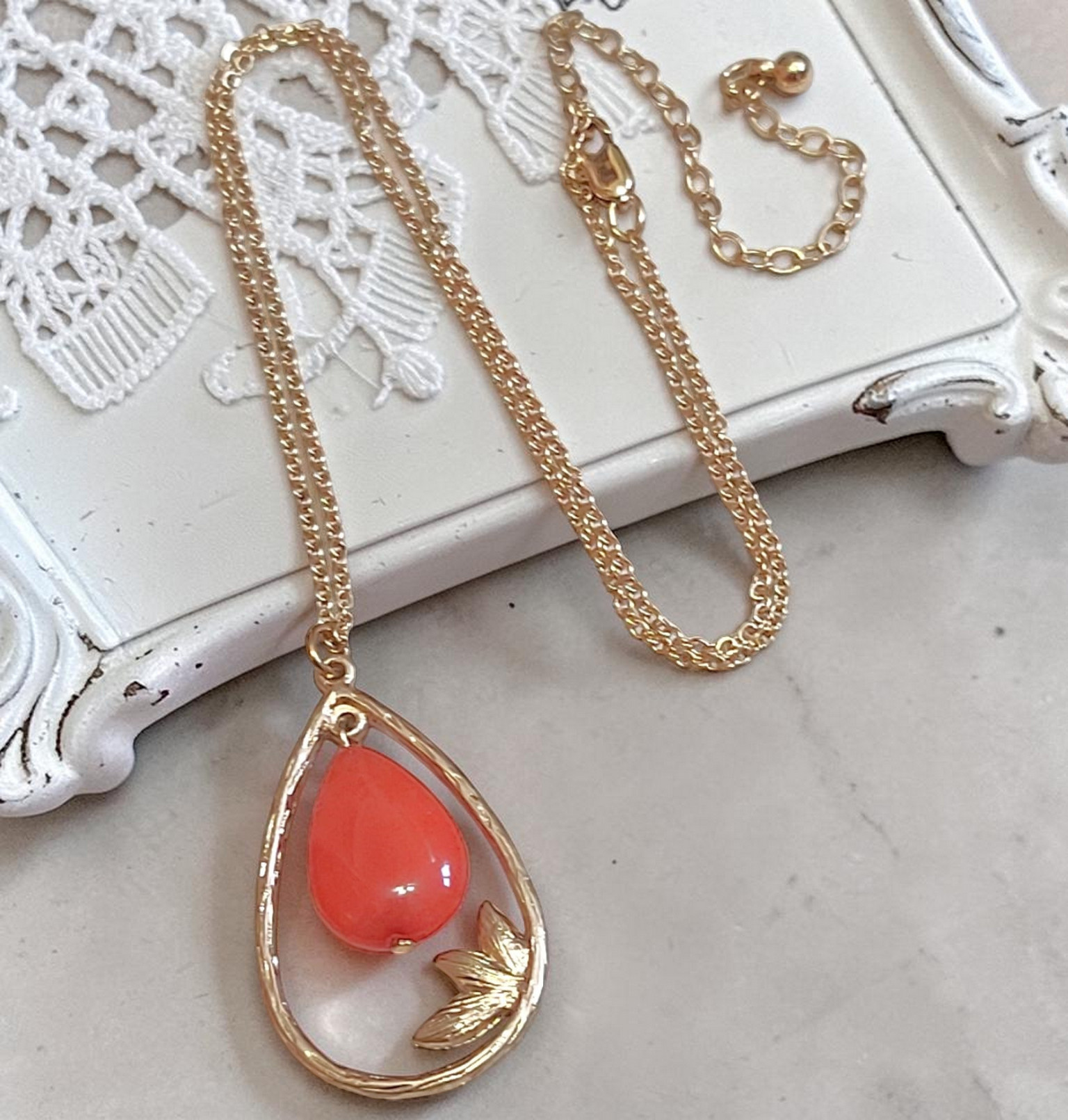 Gemstone pendant necklace, coral orange dyed quartz, with leaf pattern on chain