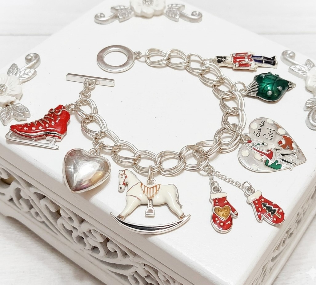 Christmas charm bracelet, ice skates, gloves, christmas heart, toy solider, rocking horse