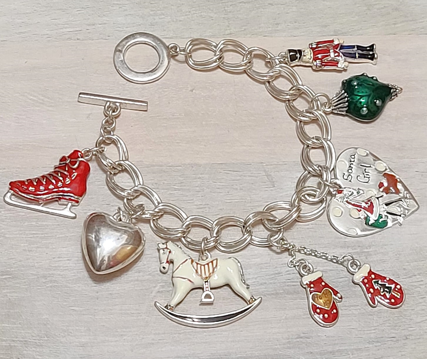 Christmas charm bracelet, ice skates, gloves, christmas heart, toy solider, rocking horse