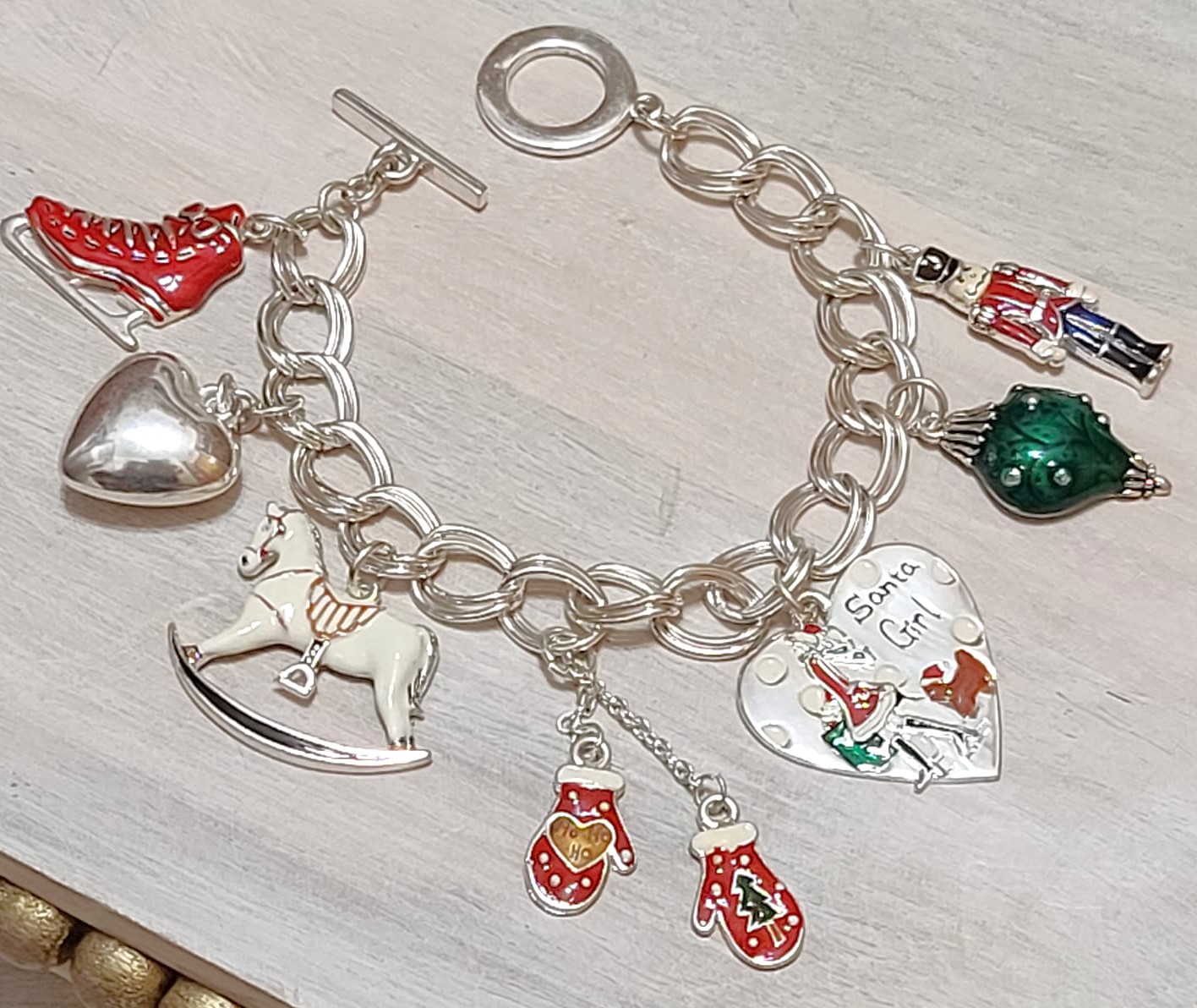 Christmas charm bracelet, ice skates, gloves, christmas heart, toy solider, rocking horse