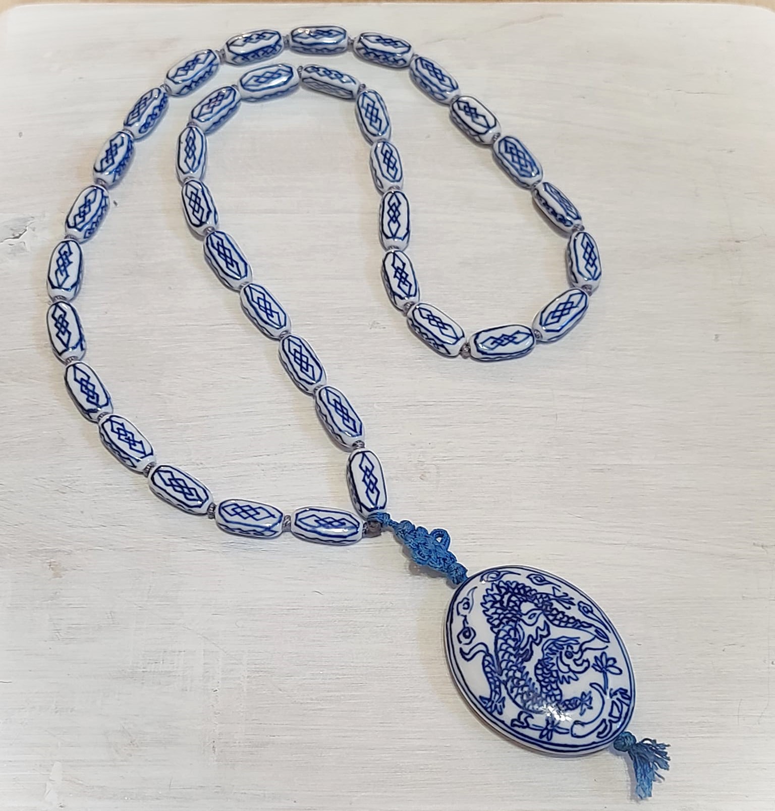 Asian ceramic beaded necklace with hanging dragon motif pendant
