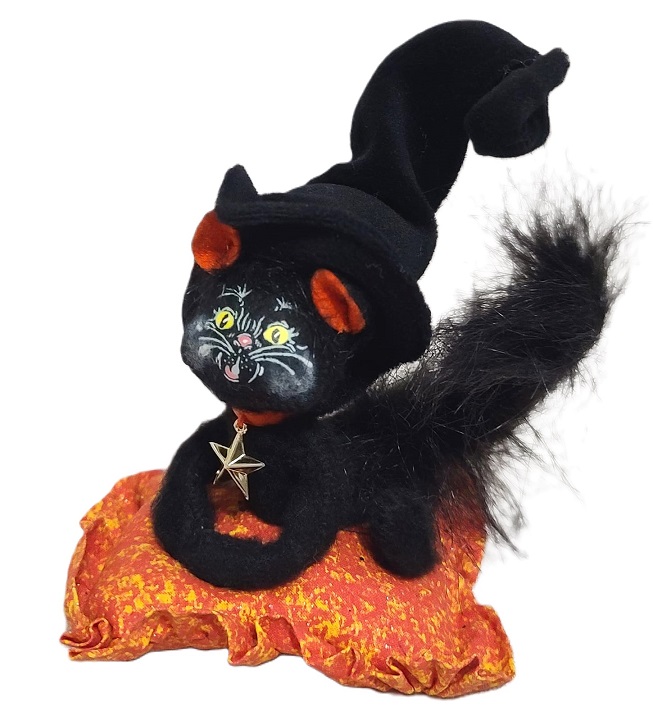 Annalee Halloween black cat sitting on an orange blanket