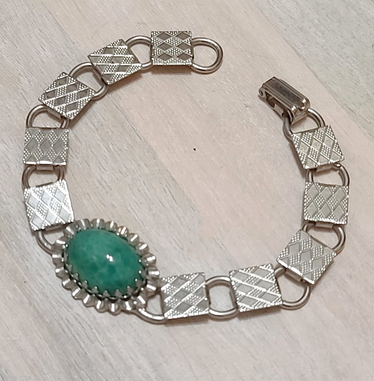 Vintage bracelet, green cabachon center, silvertone with etched detail on band