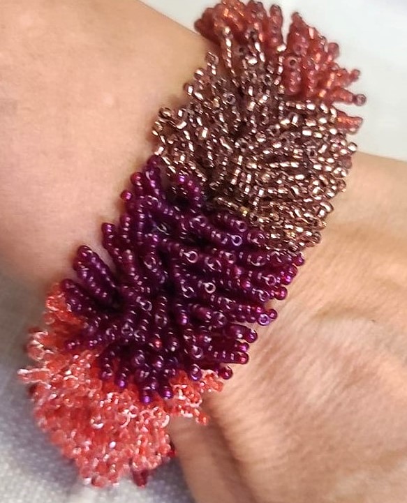 Red to Burnt Orange Hues glass bead catepillar fringe bracelet