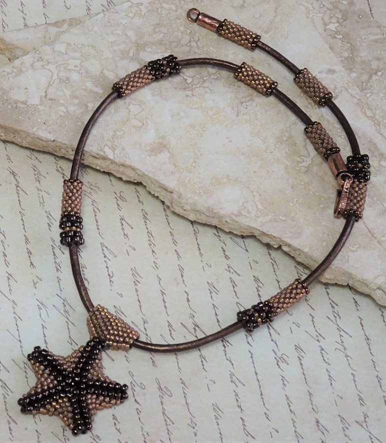 Hand sewn Bronze Starfish Pendant on metallic leather cord