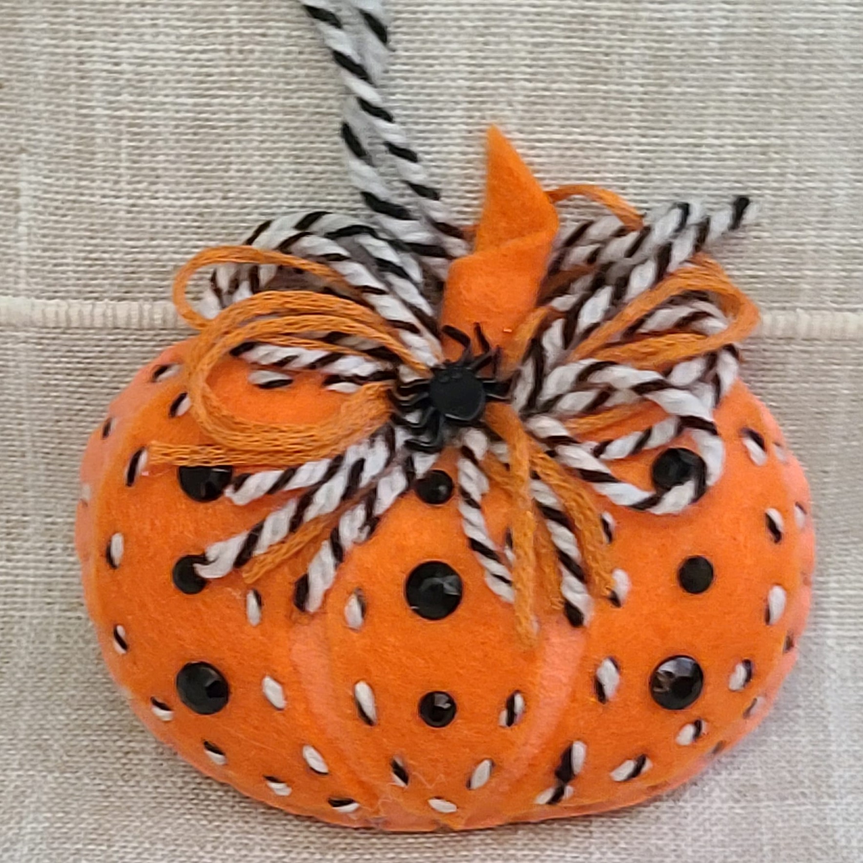 Felt pumpkin ornament - orange with black and white - Click Image to Close