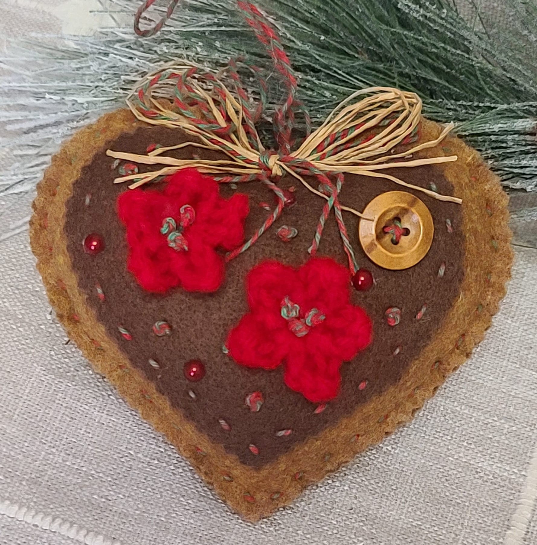 Gingerbread and chocolate icing with red accents heart ornament