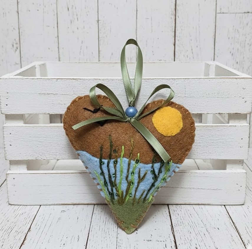 Gingerbread heart ornament with scenic pond view