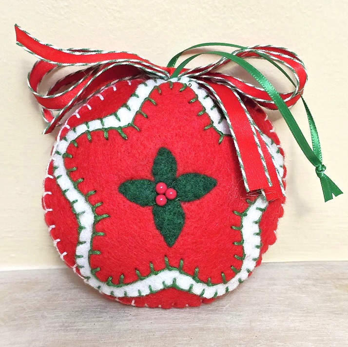Felt ornament, handmade, with center star design, red, white and green, glass bead accent